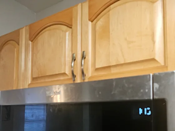 Over-range microwave with grease film before cleaning