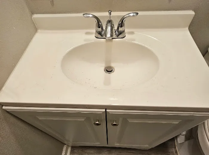 Bathroom vanity and sink cleaned and reset